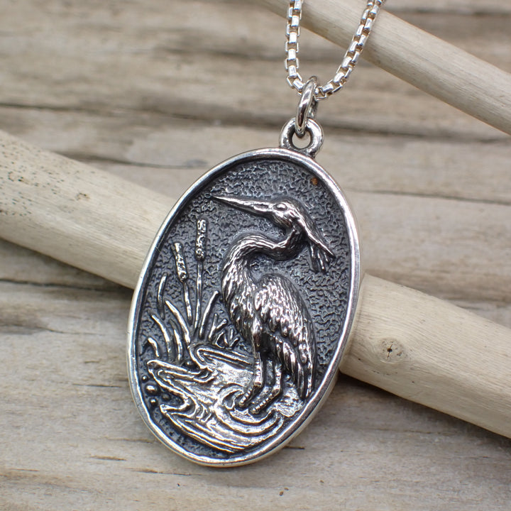 sterling silver heron charm in marsh