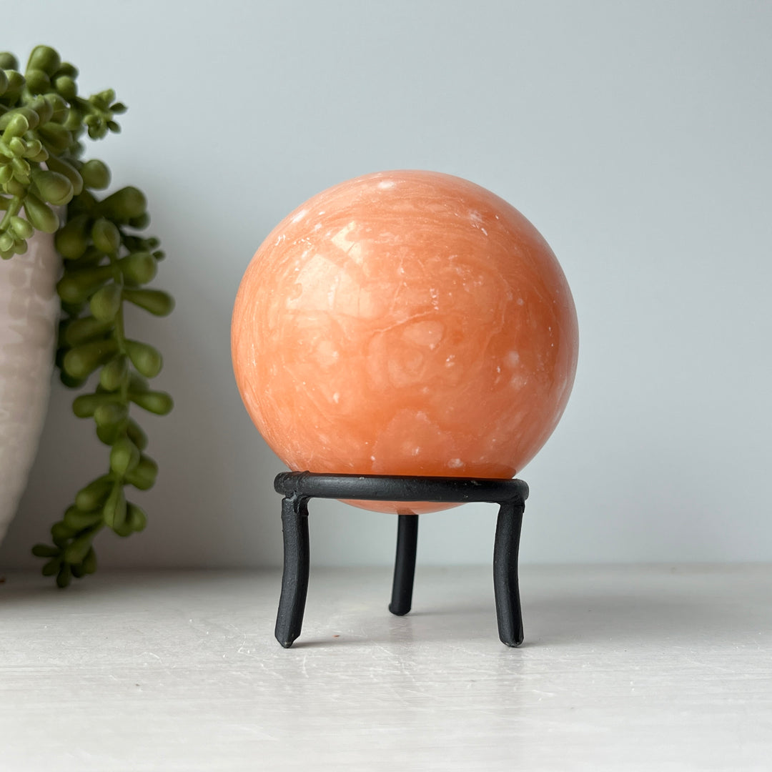 Orange Calcite Sphere on Metal Stand