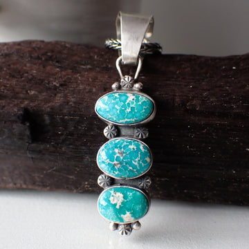 sterling silver three stone turquoise Navajo pendant necklace by artist Travis J.