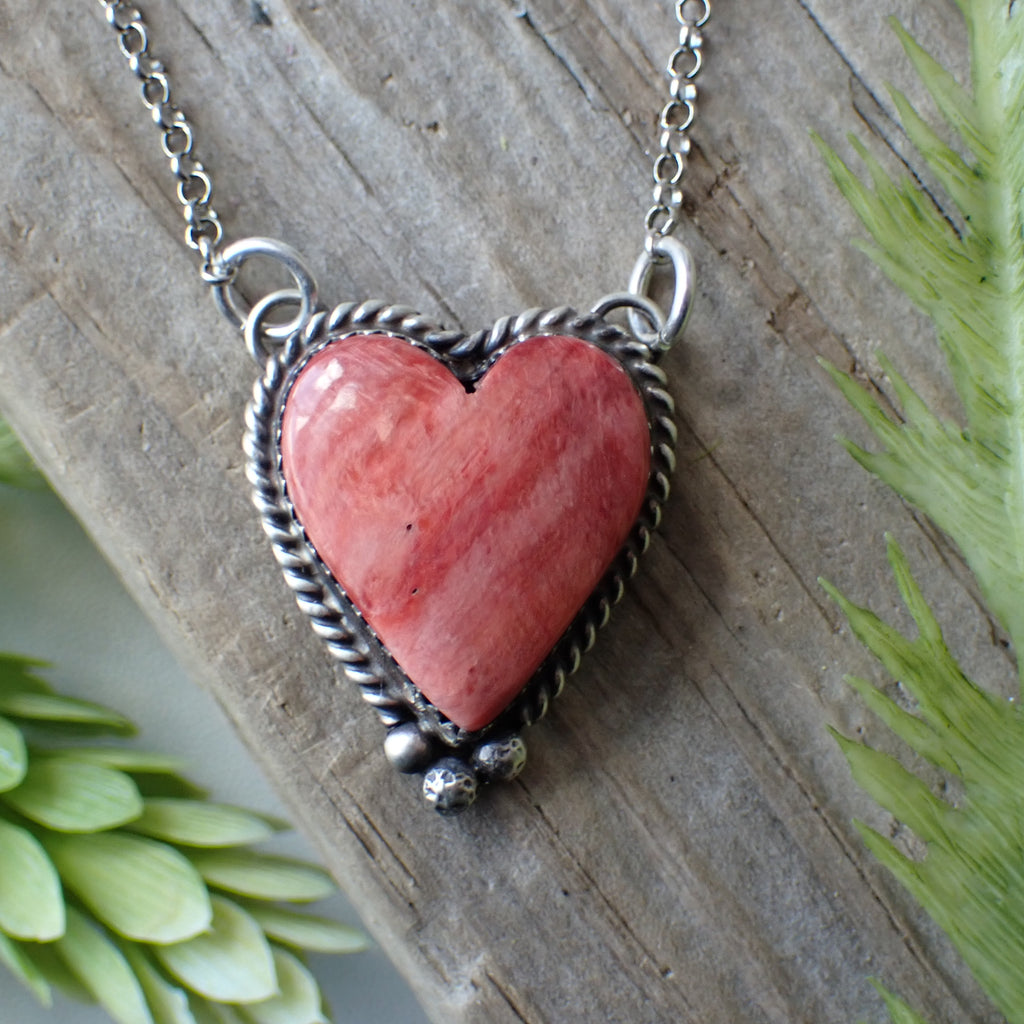 red spiny oyster  sterling silver heart necklace on driftwood
