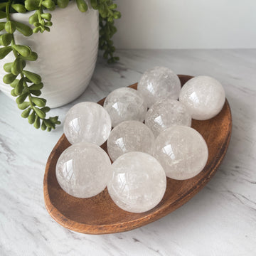 clear quartz crystal stone sphere on stand